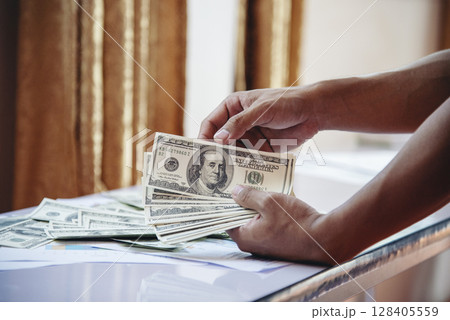 Hand holding loan money dollar bank note give financial payment. Man hands showing spread 100 dollar exchange cash payout. Saving Businessman counting money banknote bribe corruption concept. Hand holding loan money dollar bank note give financial payment. Man hands showing spread 100 dollar exchange cash payout. Saving Businessman counting money banknote bribe corruption concept. 128405559
