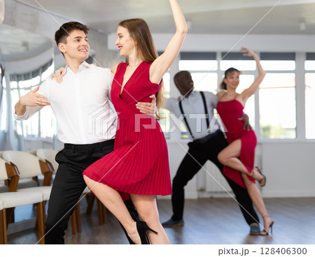 Young guy and young woman dancing tango Young guy and young woman dancing tango 128406300