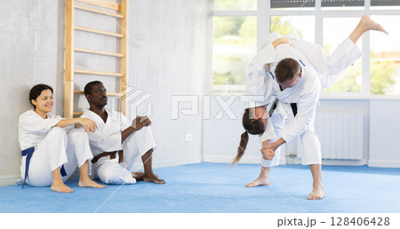 Multinational pupils train to perform defensive karate installations and attacking combat techniques Multinational pupils train to perform defensive karate installations and attacking combat techniques 128406428