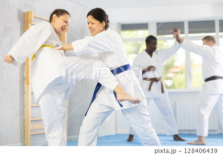 Adult and young women training judo techniques Adult and young women training judo techniques 128406439