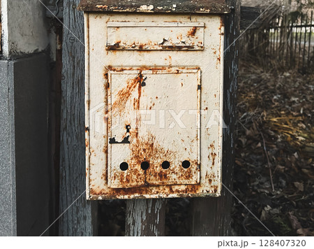 Rusty vintage mailbox in an outdoor rustic setting. Rusty vintage mailbox in an outdoor rustic setting. 128407320