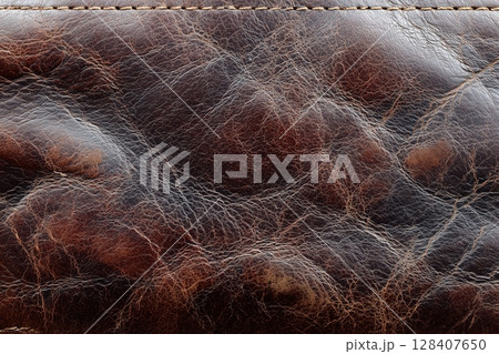Rich leather texture with worn patches and creases 128407650