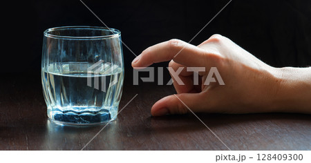 An optimist and a pessimist's opinion about a glass of water 128409300