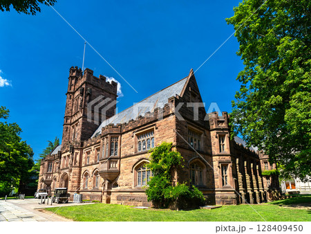 Collegiate Gothic architecture of East Pyne Hall on Princeton campus, New Jersey, featuring ornate stone detailing, arched windows, and a central tower 128409450