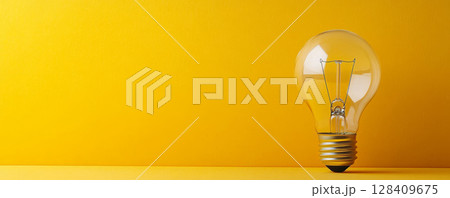 Light Bulb on Yellow Background, Symbolizing Bright Ideas Banner 128409675