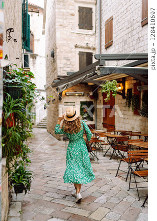 Young woman in beautiful dress walking in the street of the city. Eurotrip. Travel, tourism. Fashion 128410697