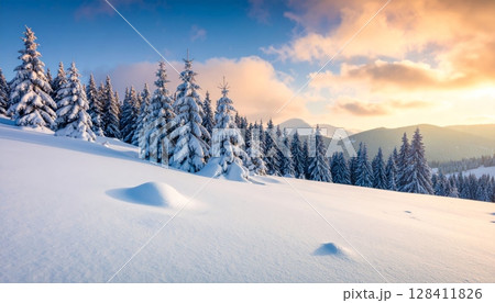 White frosty trees and snowy mountains under a blue sky create a beautiful winter landscape 128411826