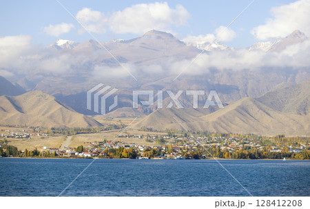 natural issyk-kul lakeside and town view in kyrgzstan with tian shan mountain range natural issyk-kul lakeside and town view in kyrgzstan with tian shan mountain range 128412208