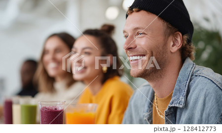 Friends enjoying colorful smoothies. Happy, healthy lifestyle concept. Perfect for nutrition, wellness, or social connection themes in ads and articles. 128412773