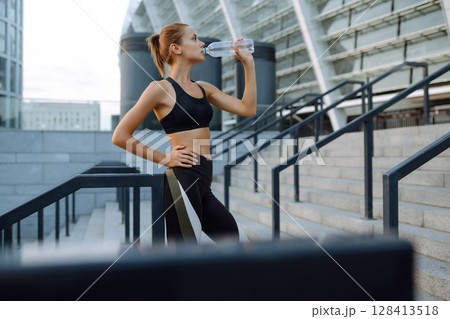 Portraits of a young sportswoman exercising outdoors. Concept of sport, active and healthy lifestyle 128413518