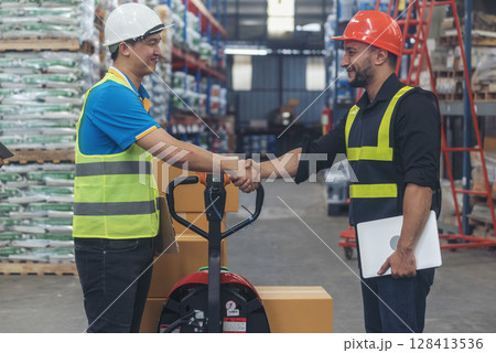 Teamwork Warehouse worker shakehand together. Engineer man hands partnership. Diversity Coworker Men logistics Warehouse teams handshake. Multiracial Support team greeting person teamwork colleagues 128413536