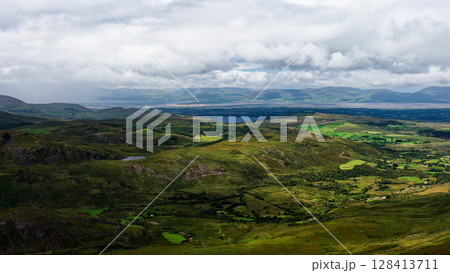 This is a picture taken from the sky of the beautiful green valleys and mountains in Coomloughra Horseshoe, Ireland. This is a picture taken from the sky of the beautiful green valleys and mountains in Coomloughra Horseshoe, Ireland. 128413711