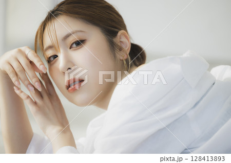 床に寝転ぶ女性 128413893