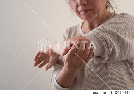 Elderly European Woman Suffering from Joint Pain, for Example in the Elbow Elderly European Woman Suffering from Joint Pain, for Example in the Elbow 128414446