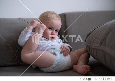 Toddler Touching Ear with Heel While Doing Gymnastics 128414461