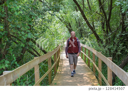 Elderly European Man Walking on an Eco-Trail in Portugal Elderly European Man Walking on an Eco-Trail in Portugal 128414507