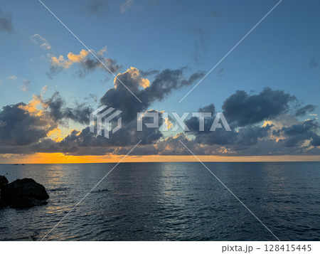 scenery from the beach to the sea with sunset clouds scenery from the beach to the sea with sunset clouds 128415445