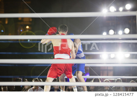 Fight of sportsmen in gloves in the ring 128415477