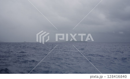 Sailing on a boat around Seychelles island on a foggy day 128416840