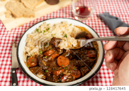 Delicious beef stew with rice on checkered tablecloth 128417645