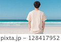 青い海を見つめるベージュTシャツの若い男性 | 後ろ姿 128417952