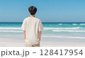 エメラルドグリーンな海と白い砂浜に立つ男子学生のTシャツ姿 | 爽やか 128417954
