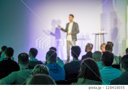 Speaker presenting to audience at a seminar or conference setting Speaker presenting to audience at a seminar or conference setting 128418035