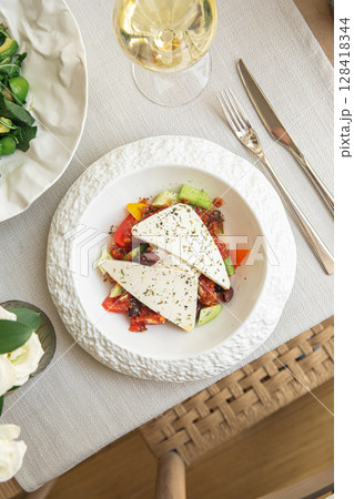 Portion of greek salad with vegetables 128418344