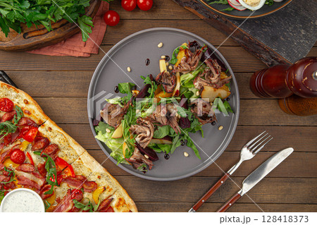 Meat salad with greens plum and pine nuts 128418373