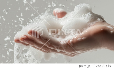 Foam being pumped into a wet hand.  128420315