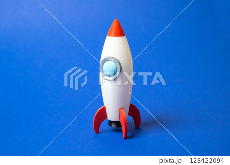 Space rocket on blue background. Concept of space aerotechnics. Advertising, startups. Advanced engineering, scientific progress, or marketing for aerospace. Tech innovation 128422094