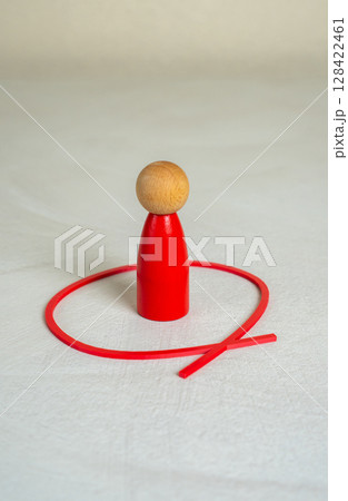 The red man is outlined by a red line. Limit yourself. Find your place. Introspection, individual boundaries, or emotional withdrawal in social contexts. 128422461