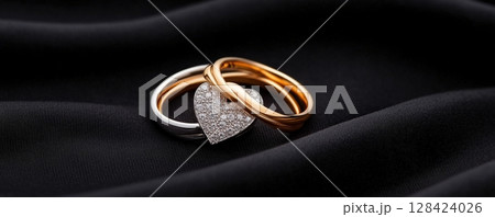 Elegant Engagement Rings on Luxurious Fabric Backdrop 128424026