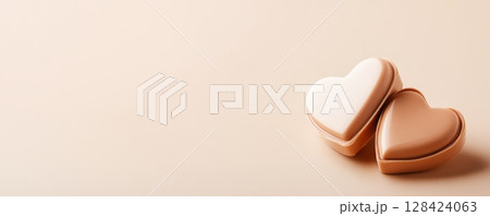 Heart shaped Chocolate Candies in Gift Box with Ribbon on Pastel Background 128424063