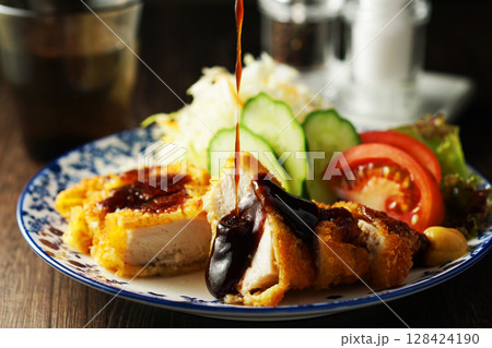 チキンカツに特製ソースをかける チキンカツに特製ソースをかける 128424190