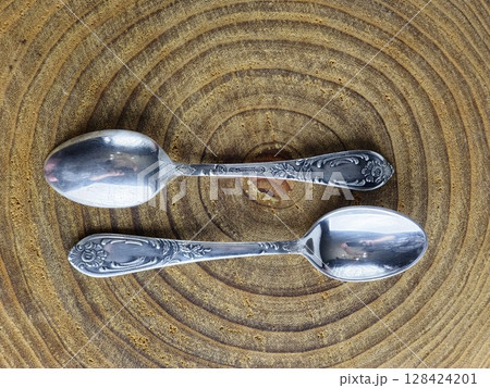 Dnipro, Ukraine - July 13, 2025: A set of vintage tea spoons made of cupronickel covered with silver. The spoons were made in USSR and are marked with a quality mark. 128424201