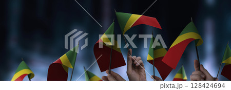 Congo flags in their hands on a blurred urban background 128424694