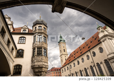 Historic Church Of The Holy Spirit In Munich: Elegant Baroque Architecture With Tower And Facade Near Marienplatz Under Dramatic Cloudy Sky Historic Church Of The Holy Spirit In Munich: Elegant Baroque Architecture With Tower And Facade Near Marienplatz Under Dramatic Cloudy Sky 128425109