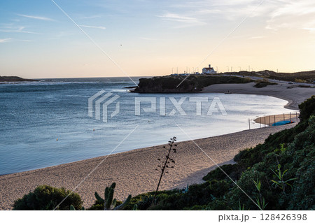 Praia do Farol in Vila Nova de Milfontes, Portugal is located at the mouth of the Mira River on the northern bank. Praia do Farol in Vila Nova de Milfontes, Portugal is located at the mouth of the Mira River on the northern bank. 128426398