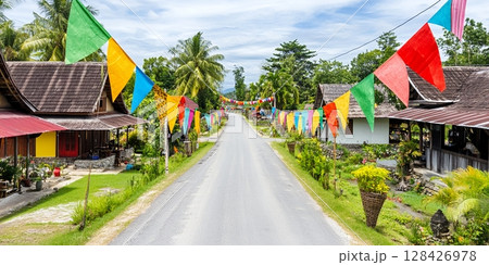 Vibrant Colorful Flags Festive Street Asian Village Tropical Road Scene red blue happy green image Vibrant Colorful Flags Festive Street Asian Village Tropical Road Scene red blue happy green image 128426978