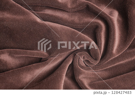 Brown velvet fabric with spiral folds Brown velvet fabric with spiral folds 128427483