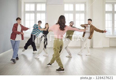 Group of young girls and guys dancing in dance studio 128427621