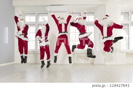 Happy New Year cute group dancing joy, partying wearing Santa Claus holiday costume, Merry Christmas 128427641