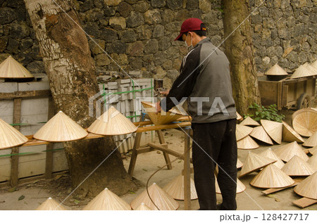 Man making hats. 128427717