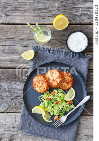 Hot Smoked salmon burgers, patties and coleslaw 128428323