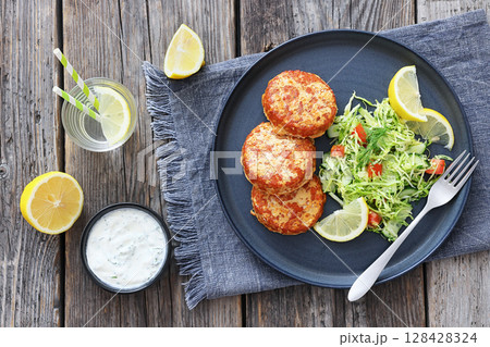 Hot Smoked salmon burgers, patties and coleslaw 128428324
