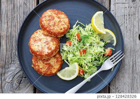 Hot Smoked salmon burgers, patties and coleslaw 128428326