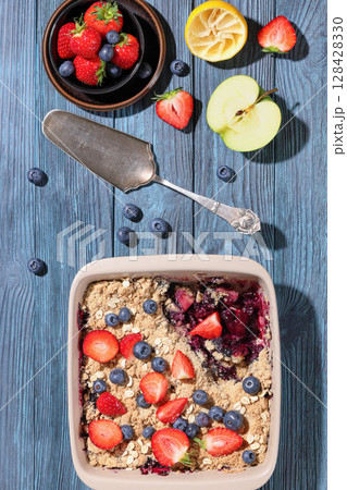 apple blueberry strawberry crumble in baking dish 128428330
