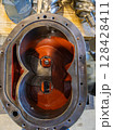 Inside view of disassembled industrial pump showing gears and housing 128428411