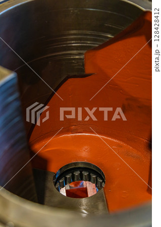 Inside view of industrial gearbox showing gears and bearings 128428412